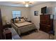 A traditionally styled bedroom with carpet, ceiling fan, and an abundance of pillows on the neatly made bed at 210 Kingsway Dr, Temple Terrace, FL 33617