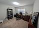 A bedroom with carpet featuring a desk, office chair, bookshelf and chest of drawers for office use at 210 Kingsway Dr, Temple Terrace, FL 33617