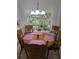 Bright dining room features hardwood table, seating for six, and large windows overlooking lush backyard at 210 Kingsway Dr, Temple Terrace, FL 33617