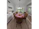 Bright dining room features hardwood table, seating for six, and large windows overlooking lush backyard at 210 Kingsway Dr, Temple Terrace, FL 33617