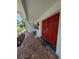 Welcoming front porch featuring double doors, brick steps, and a bench at 210 Kingsway Dr, Temple Terrace, FL 33617