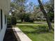 View of a grassy front yard of home with mature trees shading the property at 210 Kingsway Dr, Temple Terrace, FL 33617