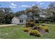 Two-story home with attached garage and landscaping. Tree shades the front yard at 210 Kingsway Dr, Temple Terrace, FL 33617