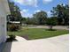 Picturesque front yard with mature trees, landscaping, and convenient circular driveway at 210 Kingsway Dr, Temple Terrace, FL 33617