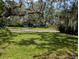 Charming home with a lush front yard, mature trees, and inviting curb appeal at 210 Kingsway Dr, Temple Terrace, FL 33617
