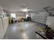 Spacious garage featuring ample storage space, overhead door, and epoxy flooring at 210 Kingsway Dr, Temple Terrace, FL 33617
