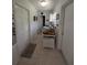 Hallway featuring tile flooring, access to multiple rooms, and natural light at 210 Kingsway Dr, Temple Terrace, FL 33617
