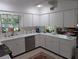 Spacious kitchen with white cabinets, stainless appliances, and plenty of countertop space at 210 Kingsway Dr, Temple Terrace, FL 33617