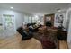 Bright living room with cozy fireplace, laminate floors, and comfortable furniture arrangement at 210 Kingsway Dr, Temple Terrace, FL 33617