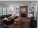 Cozy living room with a brick fireplace, built-in shelves, and comfortable seating area at 210 Kingsway Dr, Temple Terrace, FL 33617