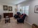 Cozy living room featuring comfortable armchairs, plantation shutters, and elegant decor at 210 Kingsway Dr, Temple Terrace, FL 33617
