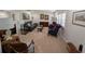 Spacious living room with neutral carpet, plantation shutters, and comfortable seating at 210 Kingsway Dr, Temple Terrace, FL 33617