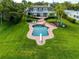 An aerial view displays the estate including a large pool, sprawling lawn, and picturesque landscaping at 224 Harbor View Ln, Largo, FL 33770