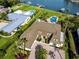 Stunning property with lush lawn, pool, and charming architecture near tranquil waters and boat dock at 224 Harbor View Ln, Largo, FL 33770
