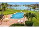 Enjoy the in-ground pool, waterfront views, and an outdoor seating area in this backyard at 224 Harbor View Ln, Largo, FL 33770