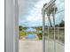 Balcony view overlooking an in-ground pool, waterfront, and surrounding neighborhood at 224 Harbor View Ln, Largo, FL 33770
