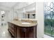 Elegant bathroom with granite countertop, dual sinks, and decorative stained glass window at 224 Harbor View Ln, Largo, FL 33770