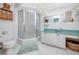 Clean bathroom featuring a glass-enclosed shower, vanity with storage, and decorative mirror at 224 Harbor View Ln, Largo, FL 33770