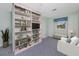 Cozy bedroom with custom bookshelves, a window seat, and a comfortable armchair at 224 Harbor View Ln, Largo, FL 33770