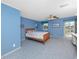 Bright bedroom with a wooden bed frame, a window with a view, and a ceiling fan at 224 Harbor View Ln, Largo, FL 33770
