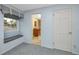 A bright bedroom includes a window seat, view to the bathroom, and large closet at 224 Harbor View Ln, Largo, FL 33770