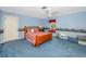 Nautical themed bedroom with blue carpet, white trim, and a built-in bench seat at 224 Harbor View Ln, Largo, FL 33770