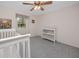 Bedroom features a crib, changing table, and natural lighting at 224 Harbor View Ln, Largo, FL 33770