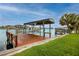 Enjoy waterfront living with a private boat dock featuring a covered lift, perfect for boating enthusiasts at 224 Harbor View Ln, Largo, FL 33770