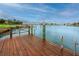 A private wooden dock with metal railings offers stunning waterfront views and convenient boat access at 224 Harbor View Ln, Largo, FL 33770