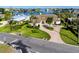 Inviting home with lush lawn, brick driveway, and classic architecture near tranquil waters at 224 Harbor View Ln, Largo, FL 33770