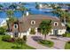 Charming home with manicured landscaping, brick driveway, and classic architectural details at 224 Harbor View Ln, Largo, FL 33770