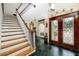 Elegant foyer with grand staircase, marble floors, and decorative front doors at 224 Harbor View Ln, Largo, FL 33770