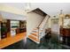 Grand foyer with elegant staircase, marble floors, and views into the living room at 224 Harbor View Ln, Largo, FL 33770