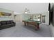 Spacious game room with a pool table, comfortable seating, and natural light from a window at 224 Harbor View Ln, Largo, FL 33770