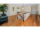 Bright hallway featuring hardwood floors, white railings, and a view of the staircase at 224 Harbor View Ln, Largo, FL 33770