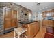Charming kitchen with exposed brick, kitchen island, built-in refrigerator and seating at 224 Harbor View Ln, Largo, FL 33770