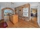 Rustic kitchen featuring brick archway and island, built-in ovens, hardwood floors, and open floor plan at 224 Harbor View Ln, Largo, FL 33770
