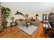 Inviting living room with hardwood floors, comfortable seating, and large decorative fish at 224 Harbor View Ln, Largo, FL 33770