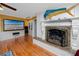 Elegant living room boasts detailed fireplace, hardwood floors and a decorative fish on the mantle at 224 Harbor View Ln, Largo, FL 33770