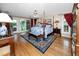 Bright and spacious main bedroom with four poster bed, hardwood floors, and backyard views at 224 Harbor View Ln, Largo, FL 33770