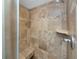Tiled shower stall featuring a built-in seat, mosaic tile accents, and a chrome shower head at 224 Harbor View Ln, Largo, FL 33770
