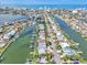 Scenic aerial view featuring waterfront homes along a canal with direct access to the ocean at 241 176Th Terrace E Dr, Redington Shores, FL 33708