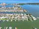 Stunning aerial view of waterfront homes, canals, and Tampa Bay in the distance at 241 176Th Terrace E Dr, Redington Shores, FL 33708