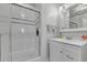 A modern bathroom featuring a shower with a glass door, bright tilework, and a white vanity at 241 176Th Terrace E Dr, Redington Shores, FL 33708