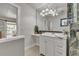 Well-lit bathroom with large mirror, stylish lighting, a sink, and tile-look walls at 241 176Th Terrace E Dr, Redington Shores, FL 33708