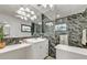 Clean and modern bathroom with a sink, ample counter space, and tile-look walls at 241 176Th Terrace E Dr, Redington Shores, FL 33708