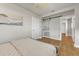 View of a light-filled bedroom featuring wood floors and a white sliding door leading to a wardrobe at 241 176Th Terrace E Dr, Redington Shores, FL 33708