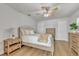 Clean bedroom with a ceiling fan, and wood-look flooring featuring a dresser with storage at 241 176Th Terrace E Dr, Redington Shores, FL 33708