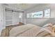 Bright bedroom with large windows, ceiling fan, wood floor and sliding barn door leading to a wardrobe at 241 176Th Terrace E Dr, Redington Shores, FL 33708