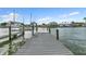 Long wooden dock extending into the water with boat lifts, great for boating and fishing at 241 176Th Terrace E Dr, Redington Shores, FL 33708